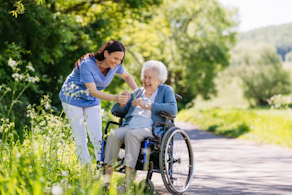 Life Assure Senior Woman Sitting In Chair And Laughing With Caregiver Nurse Blog